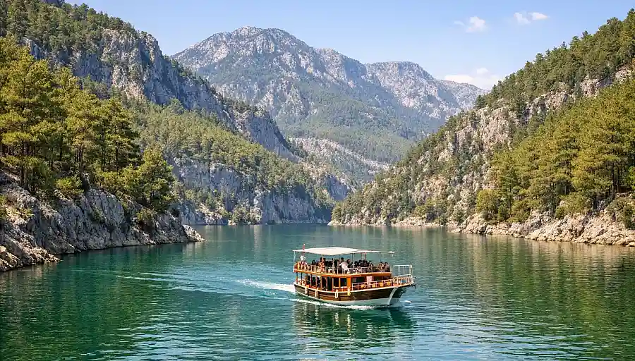 Łódź na spokojnych, zielonych wodach Green Canyon koło Manavgat, wśród sosnowych wzgórz